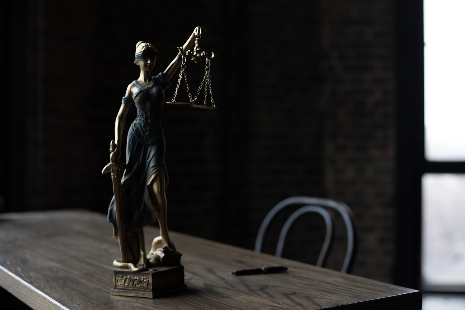 A Figurine of the Lady Justice on a Table